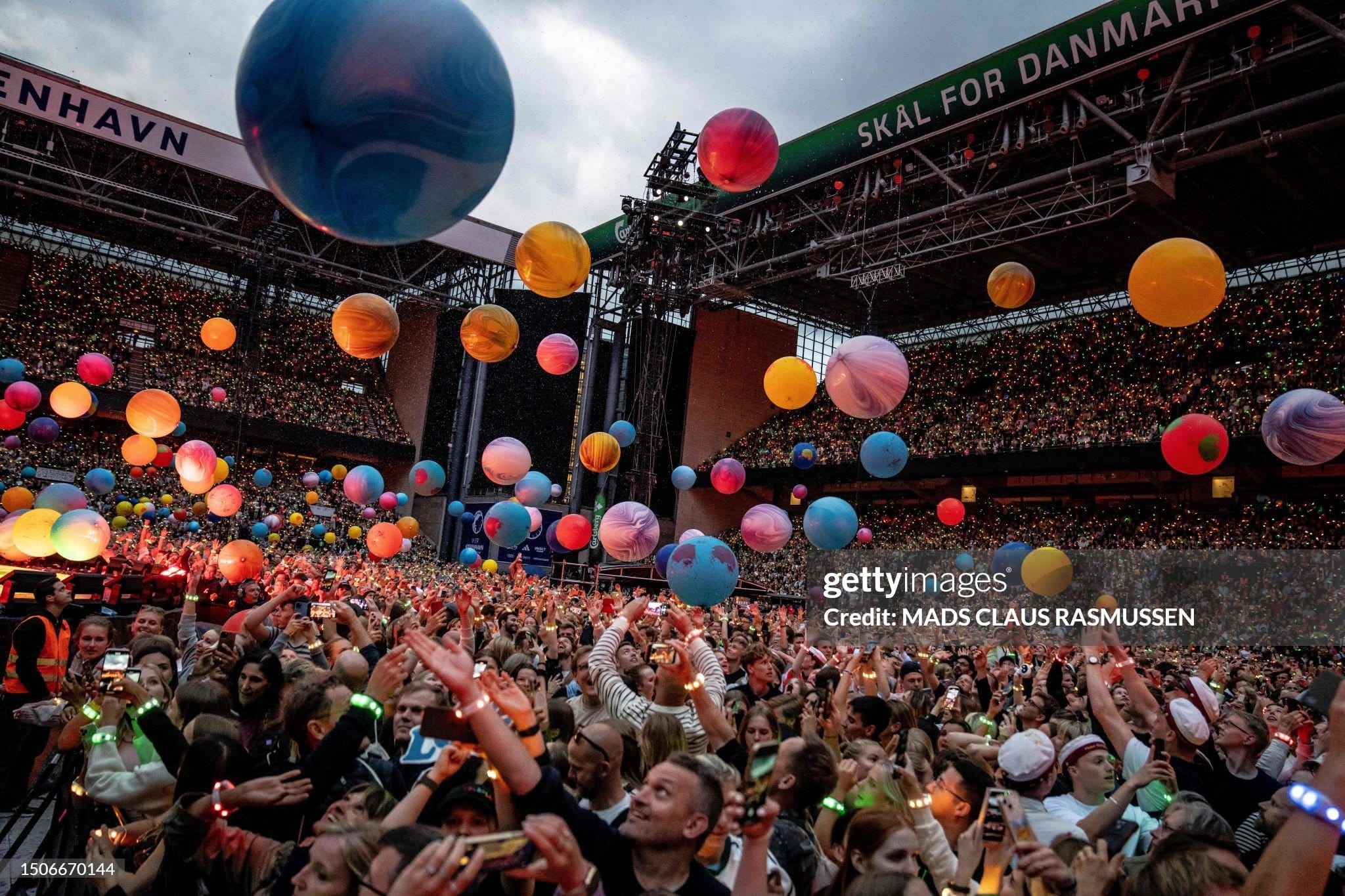 Fans cheer as British singer Chris Martin of British band Coldplay performs at Parken Stadium in Copenhagen, on July 5, 2023. The concert is part of the Music of the Spheres World Tour. (Photo by Mads Claus Rasmussen / Ritzau Scanpix / AFP) / Denmark OUT (Photo by MADS CLAUS RASMUSSEN/Ritzau Scanpix/AFP via Getty Images)