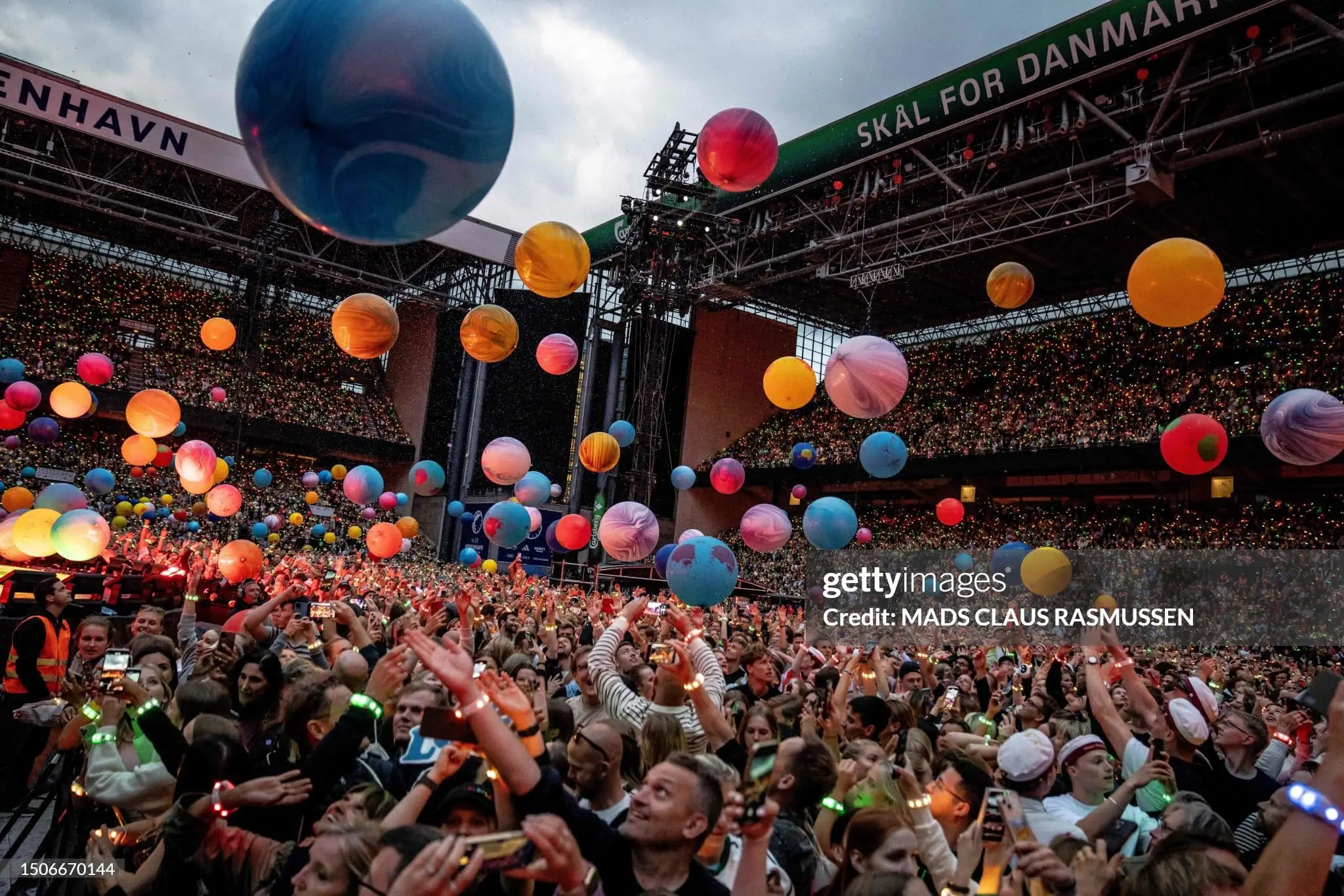 Fans cheer as British singer Chris Martin of British band Coldplay performs at Parken Stadium in Copenhagen, on July 5, 2023. The concert is part of the Music of the Spheres World Tour. (Photo by Mads Claus Rasmussen / Ritzau Scanpix / AFP) / Denmark OUT (Photo by MADS CLAUS RASMUSSEN/Ritzau Scanpix/AFP via Getty Images)