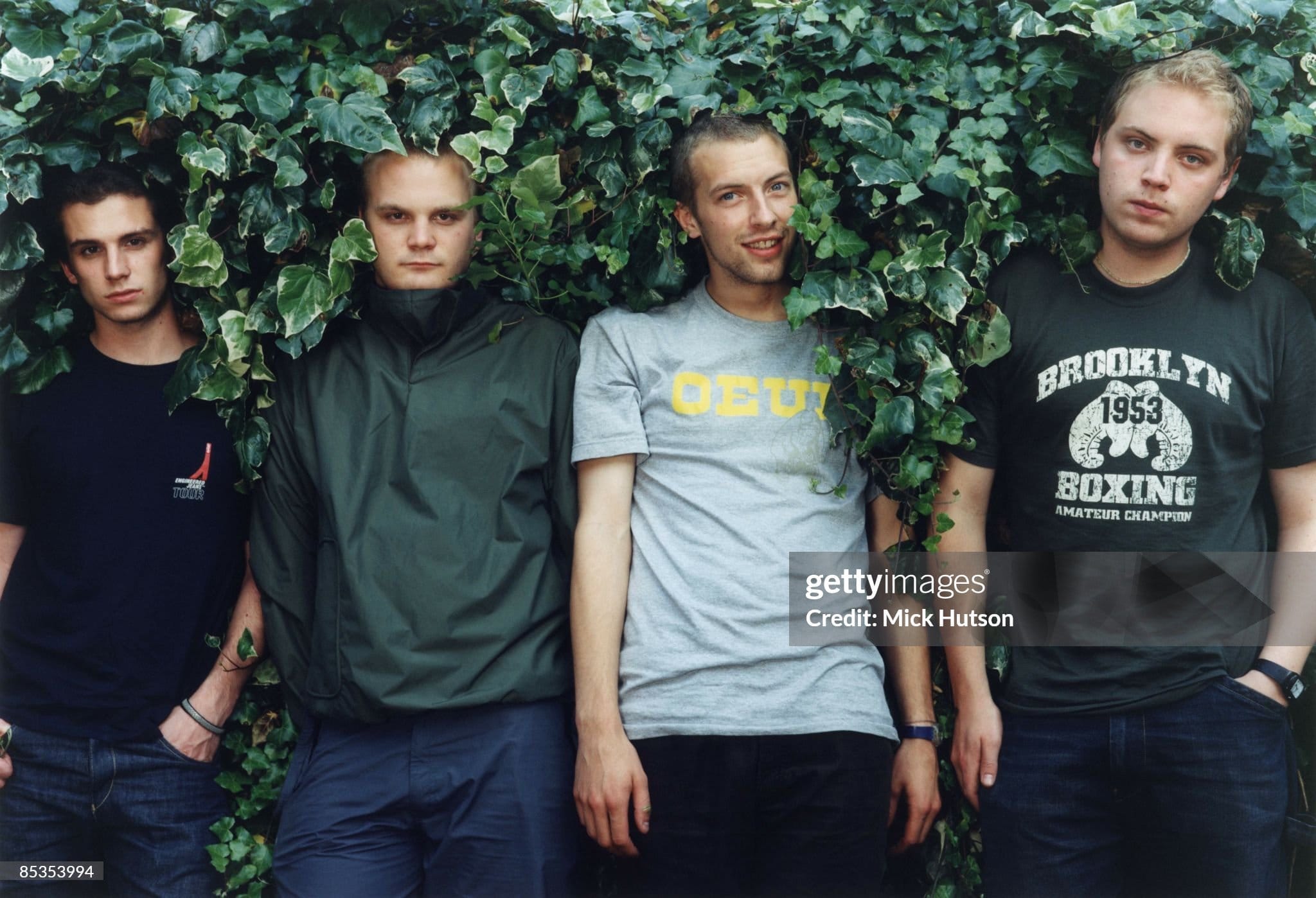 UNITED KINGDOM - JULY 01:  Photo of Chris MARTIN and COLDPLAY and Jonny BUCKLAND and Will CHAMPION and Guy BERRYMAN; Posed group portrait in hedge L-R Guy Berryman, Will Champion, Chris Martin and Jonny Buckland  (Photo by Mick Hutson/Redferns)